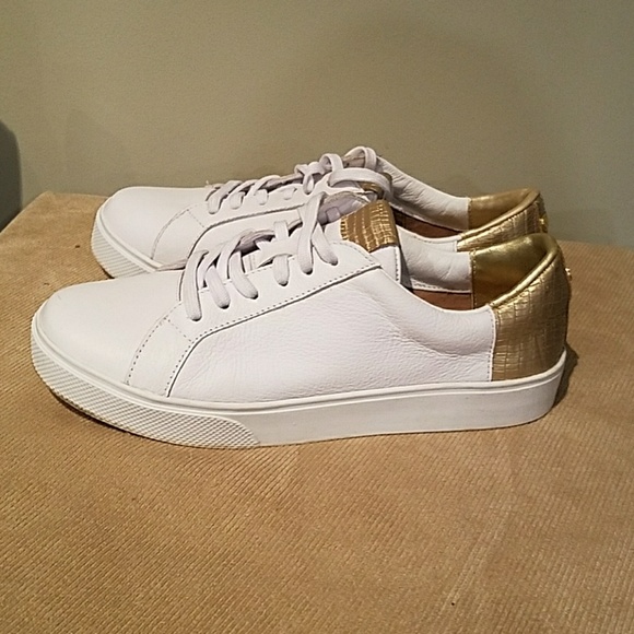 white sneakers with gold accents